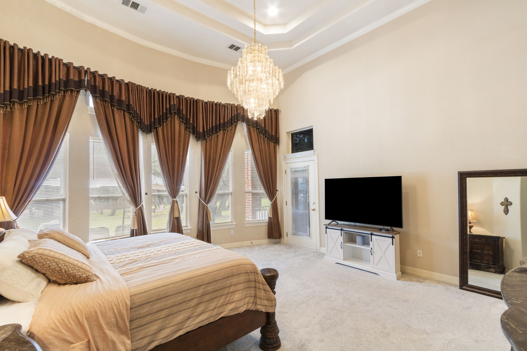15 Sarazen Loop North Georgetown, TX 78628 - Photo 22 of 40 Bedroom with a chandelier, baseboards, a high ceiling, carpet, and ornamental molding