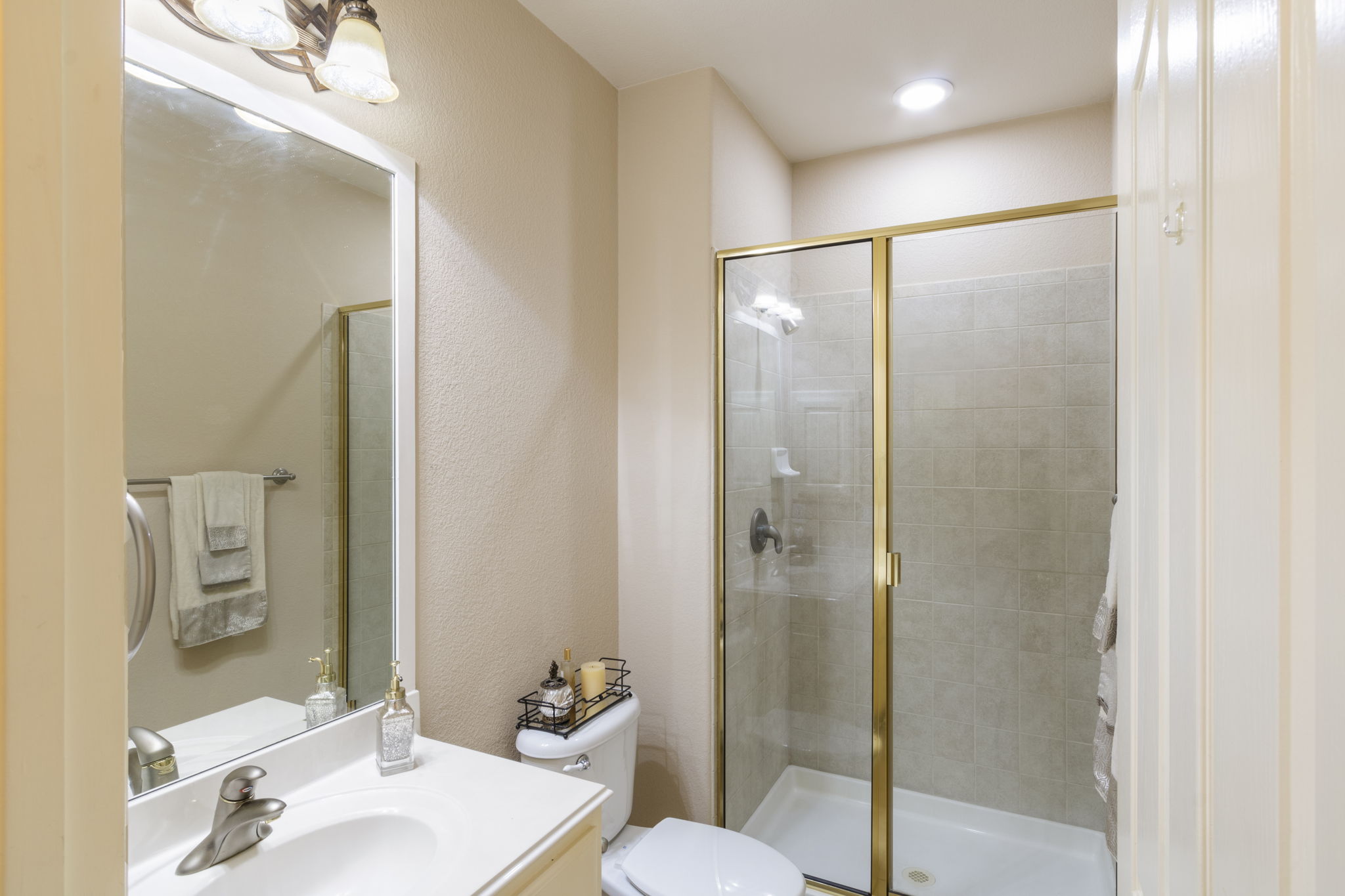 15 Sarazen Loop North Georgetown, TX 78628 - Photo 24 of 40 Bathroom featuring a stall shower, vanity, and toilet