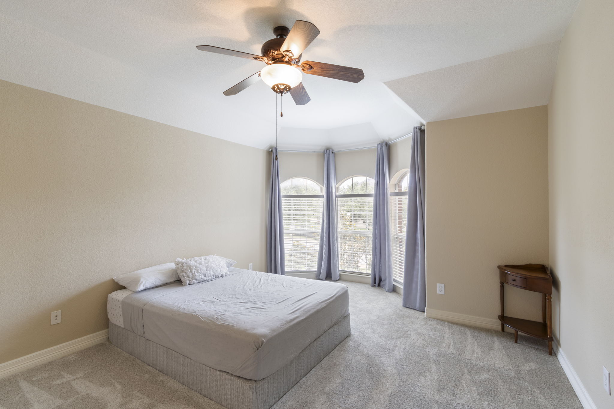 15 Sarazen Loop North Georgetown, TX 78628 - Photo 33 of 40 Bedroom with light carpet, a ceiling fan, and baseboards