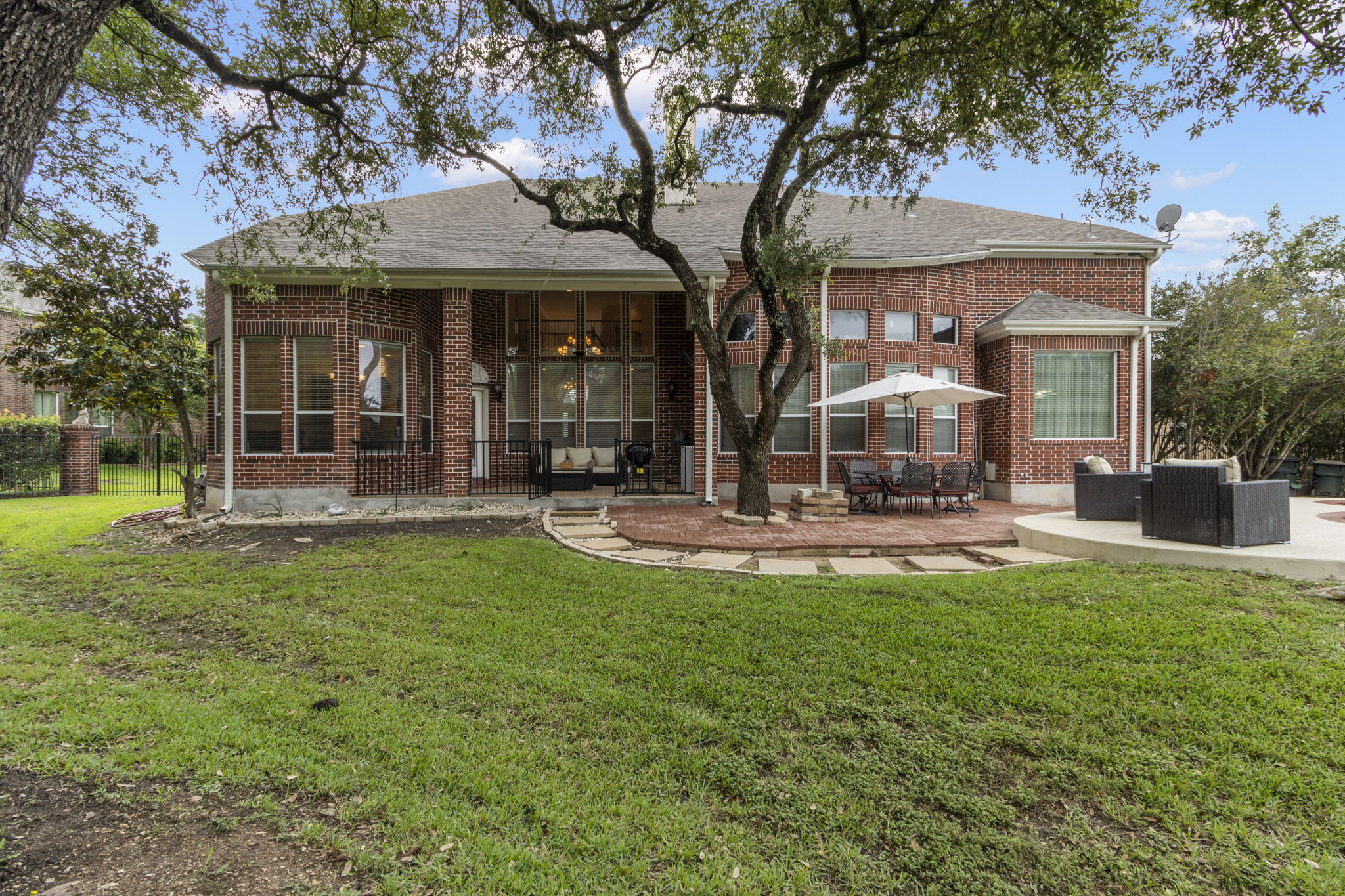 15 Sarazen Loop North Georgetown, TX 78628 - Photo 38 of 40 Rear view of property with brick siding, a patio area, and roof with shingles
