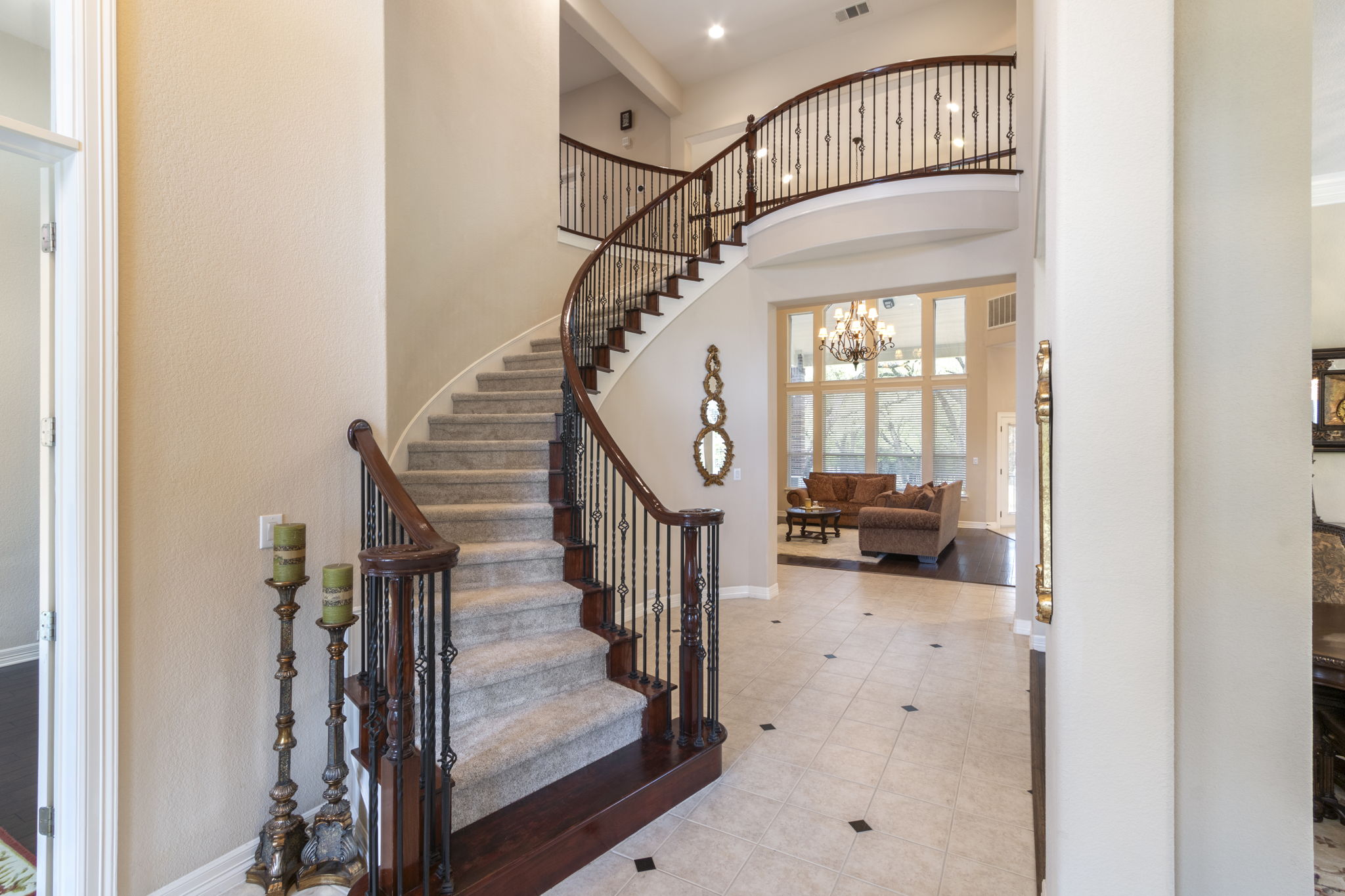 15 Sarazen Loop North Georgetown, TX 78628 - Photo 6 of 40 Tiled foyer entrance featuring baseboards, a high ceiling, stairway, and a chandelier