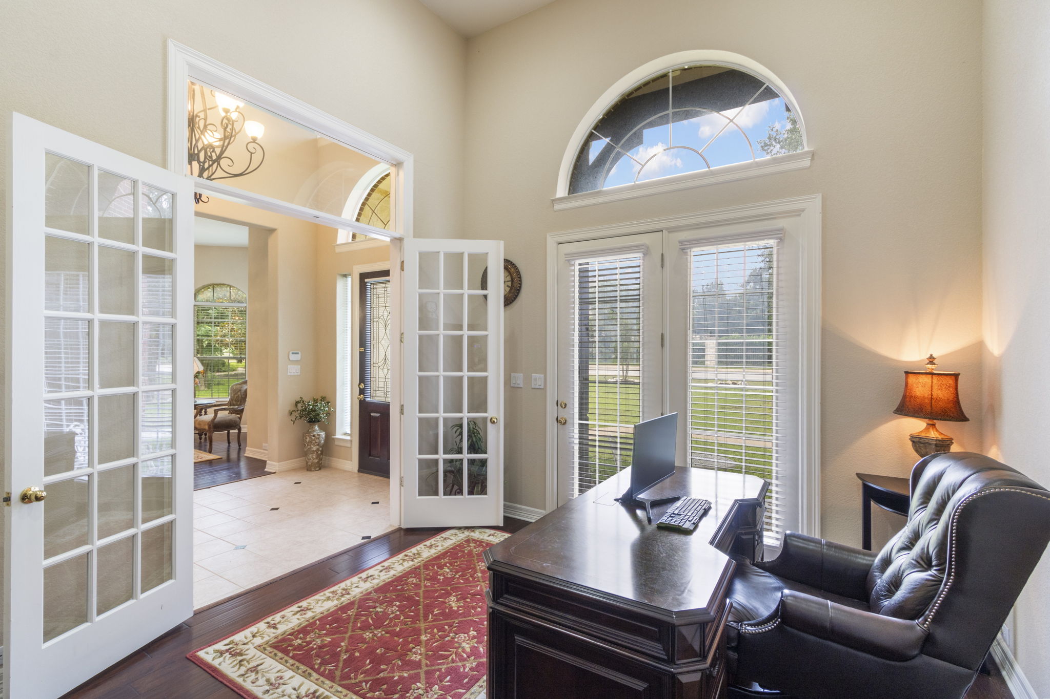 15 Sarazen Loop North Georgetown, TX 78628 - Photo 7 of 40 Office area featuring french doors, plenty of natural light, dark wood-type flooring, and a towering ceiling