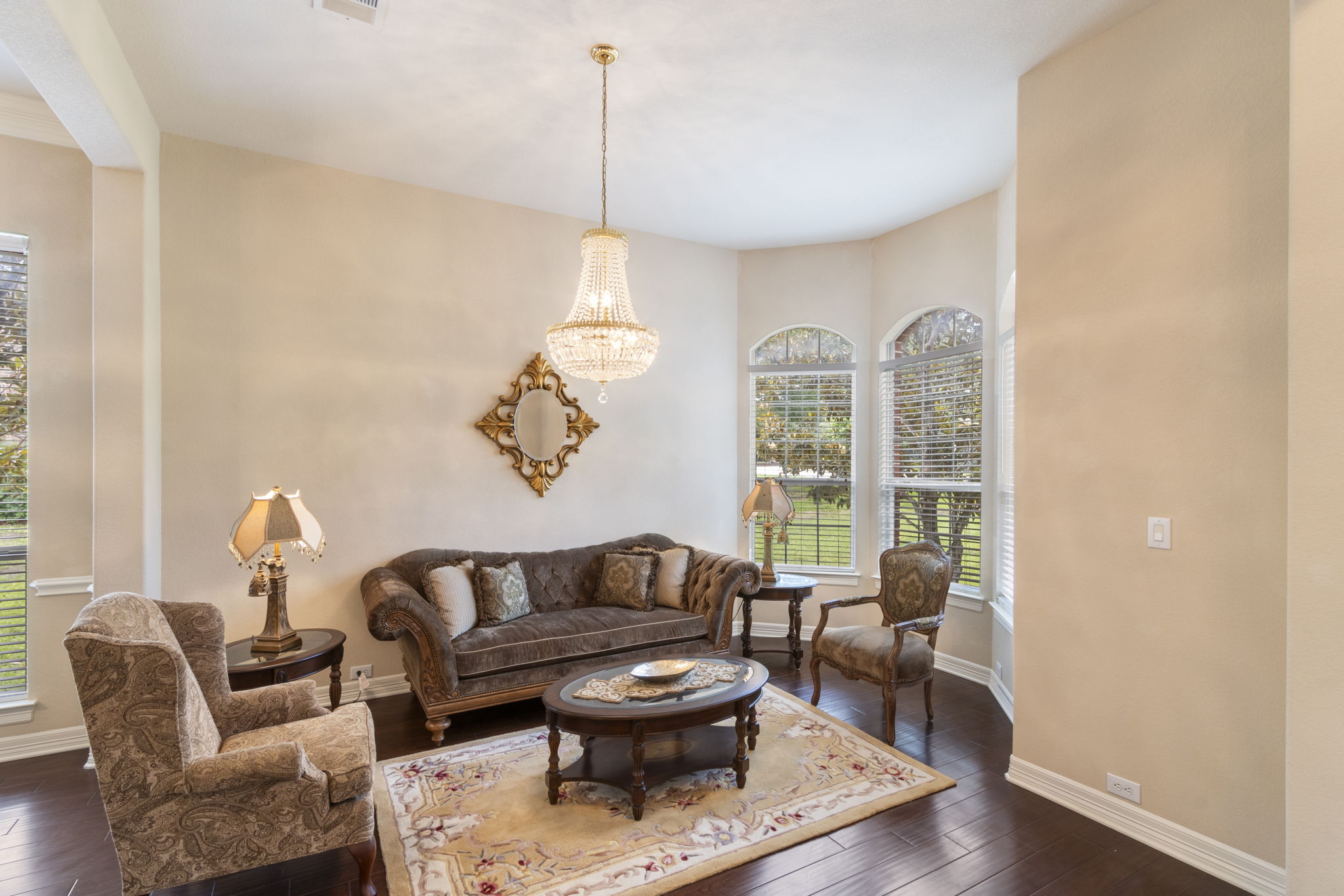 15 Sarazen Loop North Georgetown, TX 78628 - Photo 8 of 40 Living area featuring dark wood-style floors, baseboards, and a chandelier
