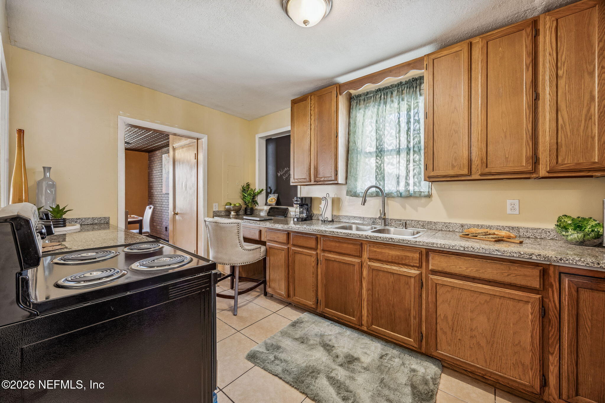 426 Aiken Road Jacksonville, FL 32216 - Photo 32 of 50 a kitchen with granite countertop a sink stove and cabinets