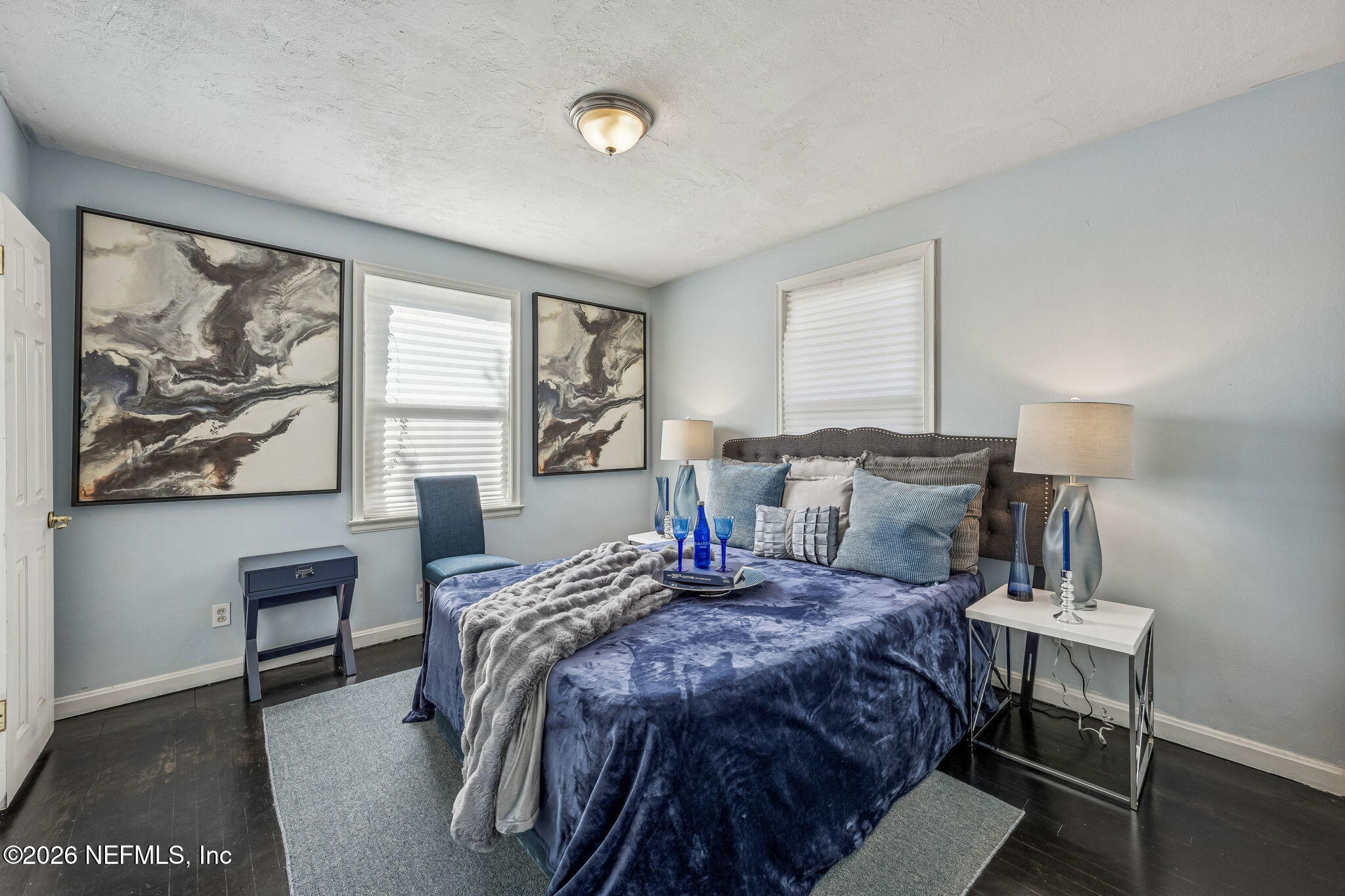 426 Aiken Road Jacksonville, FL 32216 - Photo 35 of 50 a bedroom with a bed a table and painting on the wall