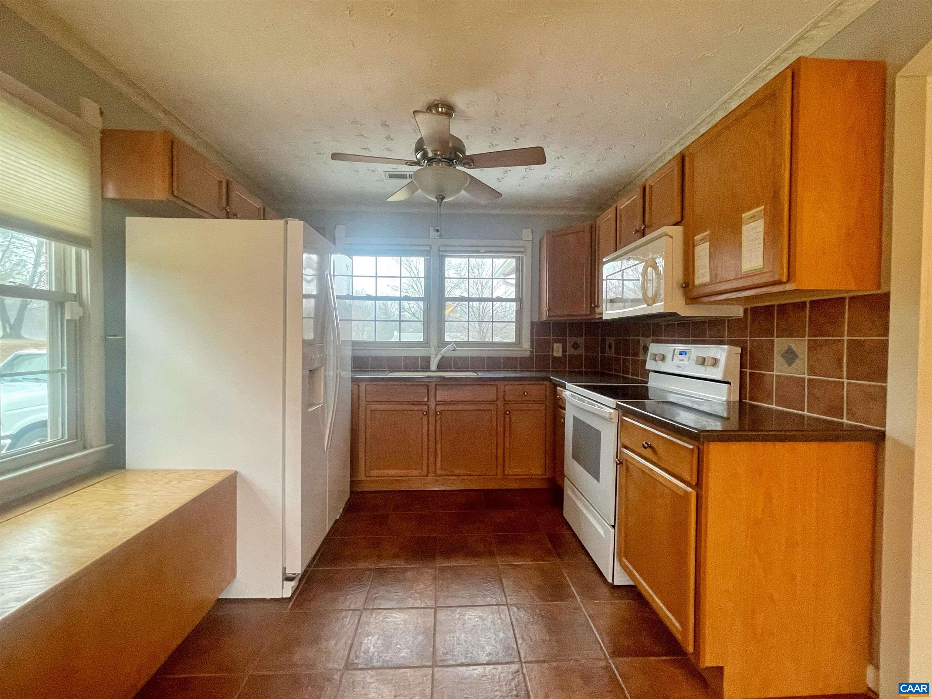 384 Carpenters Mill Road Ruckersville, VA 22968 - Photo 11 of 27 a kitchen with stainless steel appliances granite countertop a refrigerator and a stove top oven