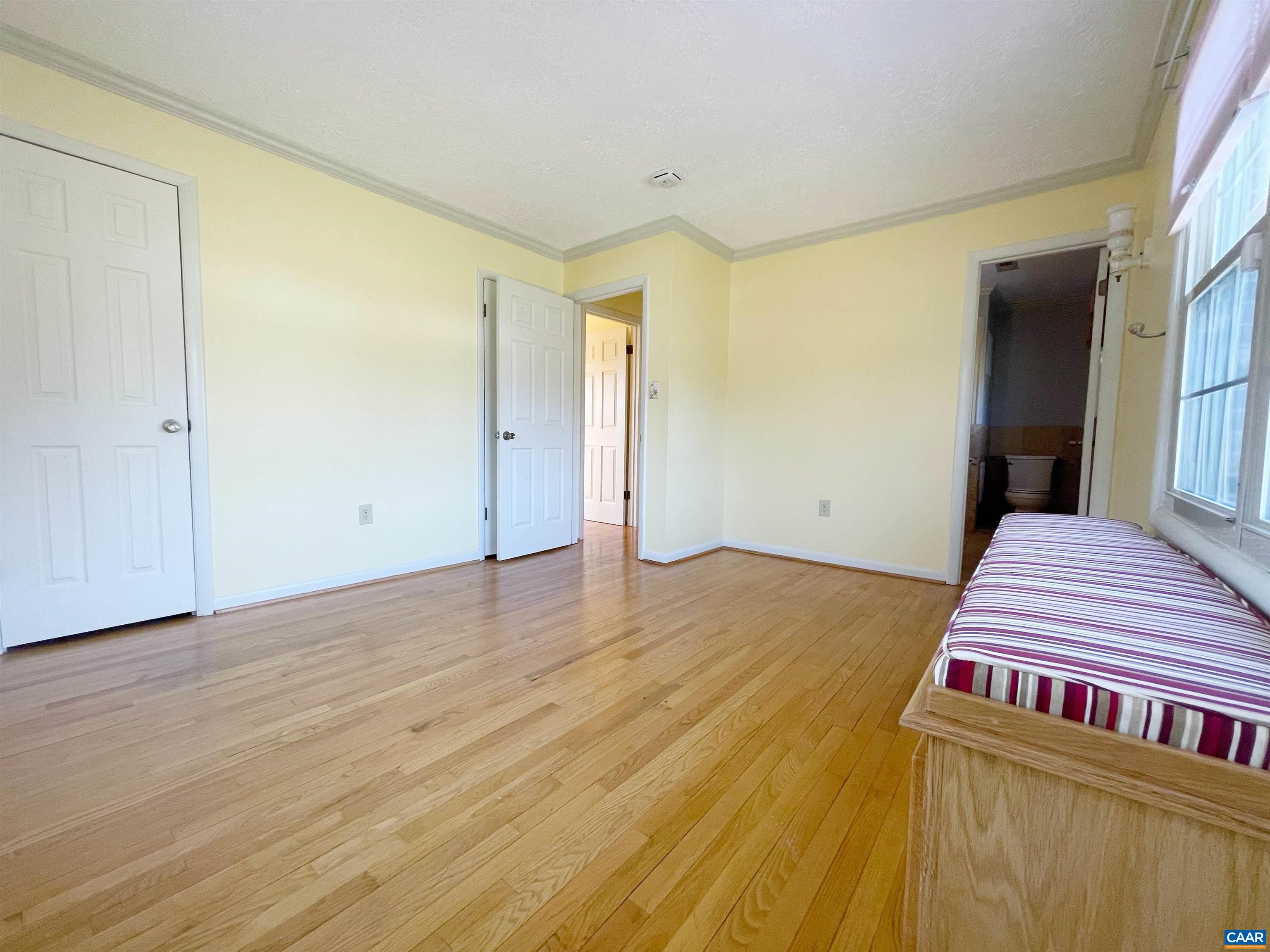 384 Carpenters Mill Road Ruckersville, VA 22968 - Photo 14 of 27 a bedroom with a bed and wooden floor