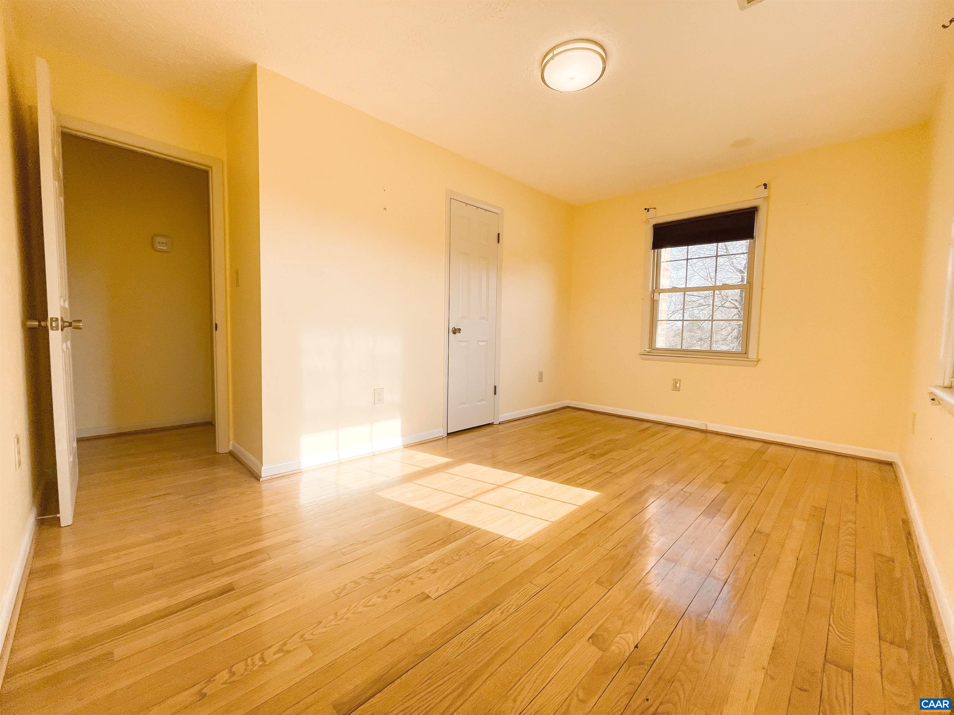 384 Carpenters Mill Road Ruckersville, VA 22968 - Photo 18 of 27 a view of empty room with wooden floor and fan