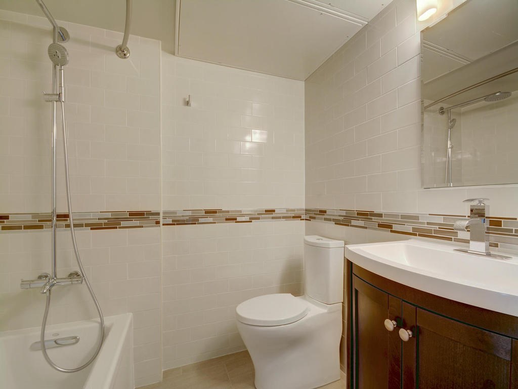 3110 Red River Street, Unit 206 Austin, TX 78705 - Photo 3 of 11 a bathroom with a sink a toilet and shower