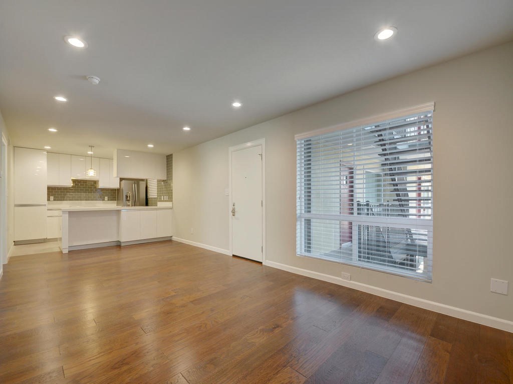 3110 Red River Street, Unit 206 Austin, TX 78705 - Photo 4 of 11 a view of an empty room with wooden floor and a window