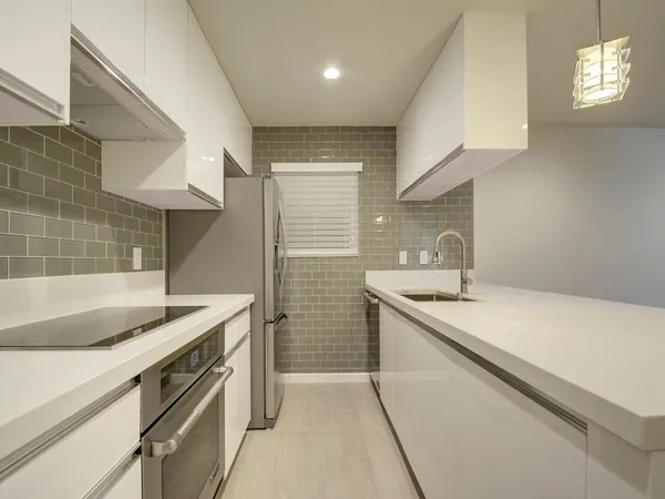 a kitchen with a sink stove and cabinets
