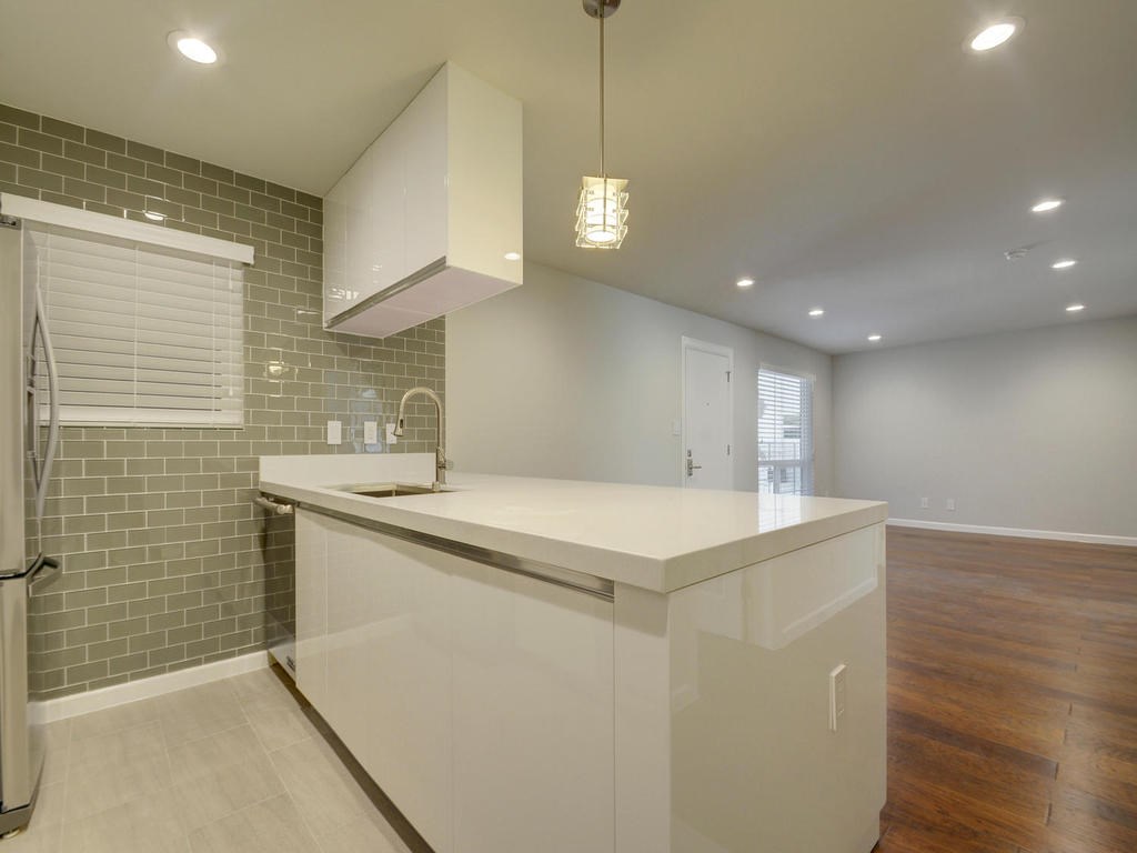 3110 Red River Street, Unit 206 Austin, TX 78705 - Photo 6 of 11 a kitchen with stainless steel appliances a sink a stove a refrigerator and cabinets