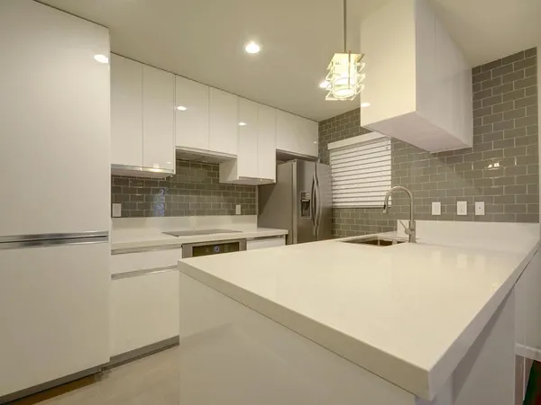 a large kitchen with kitchen island a sink stainless steel appliances and cabinets