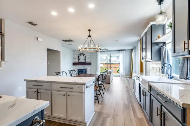 a view of a dining room with furniture a chandelier and wooden floor