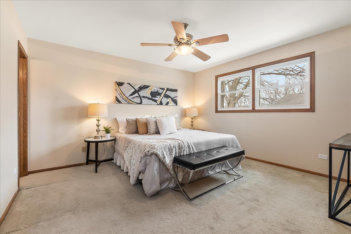 267 Center Road Frankfort, IL 60423 - Photo 14 of 26 a spacious bedroom with a bed and a chandelier