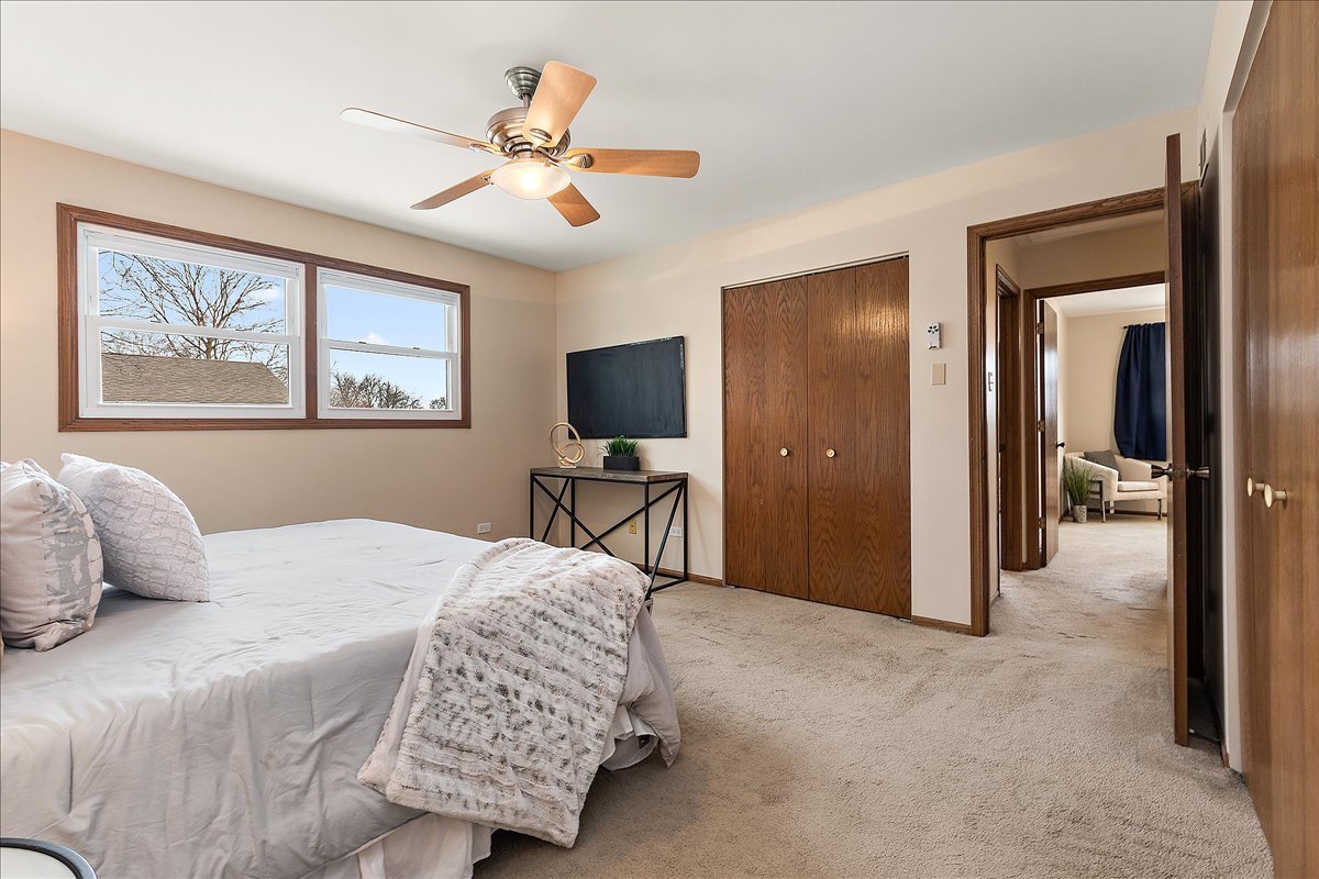 267 Center Road Frankfort, IL 60423 - Photo 15 of 26 a bedroom with a bed and a chandelier