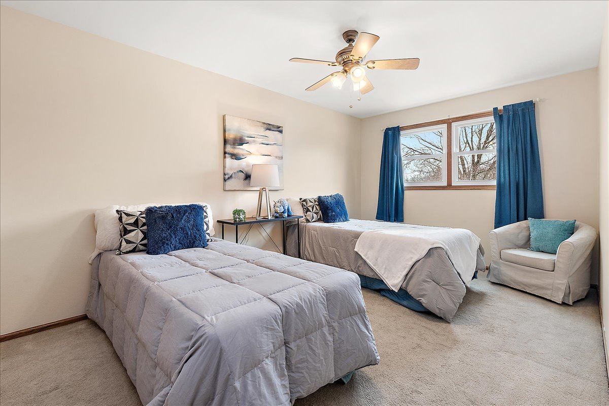 267 Center Road Frankfort, IL 60423 - Photo 17 of 26 a bedroom with two beds and a chandelier