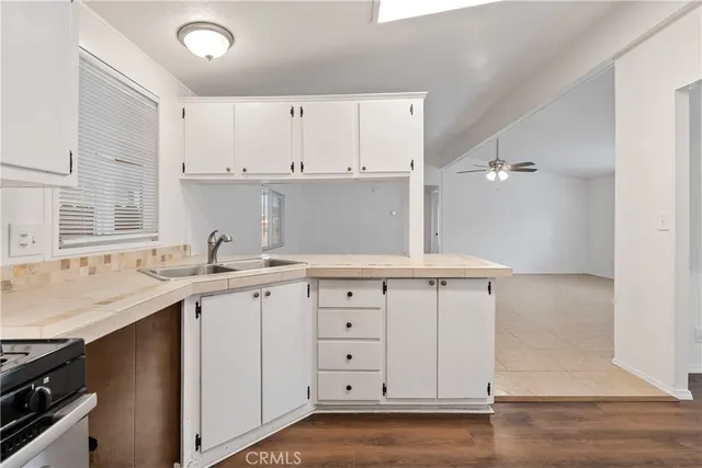 a kitchen with a sink cabinets and wooden floor