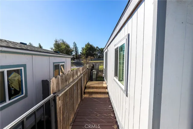a view of a house with deck and furniture