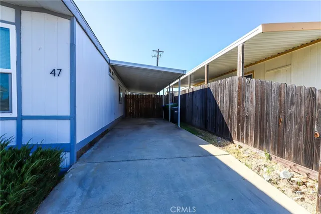 a view of a house with a yard and potted plants