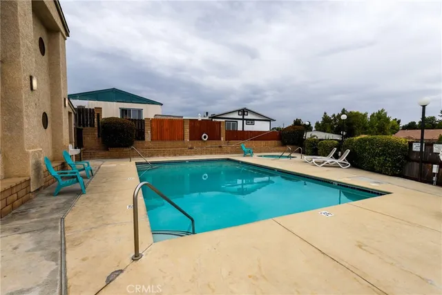 an outdoor sitting area with couch and chairs