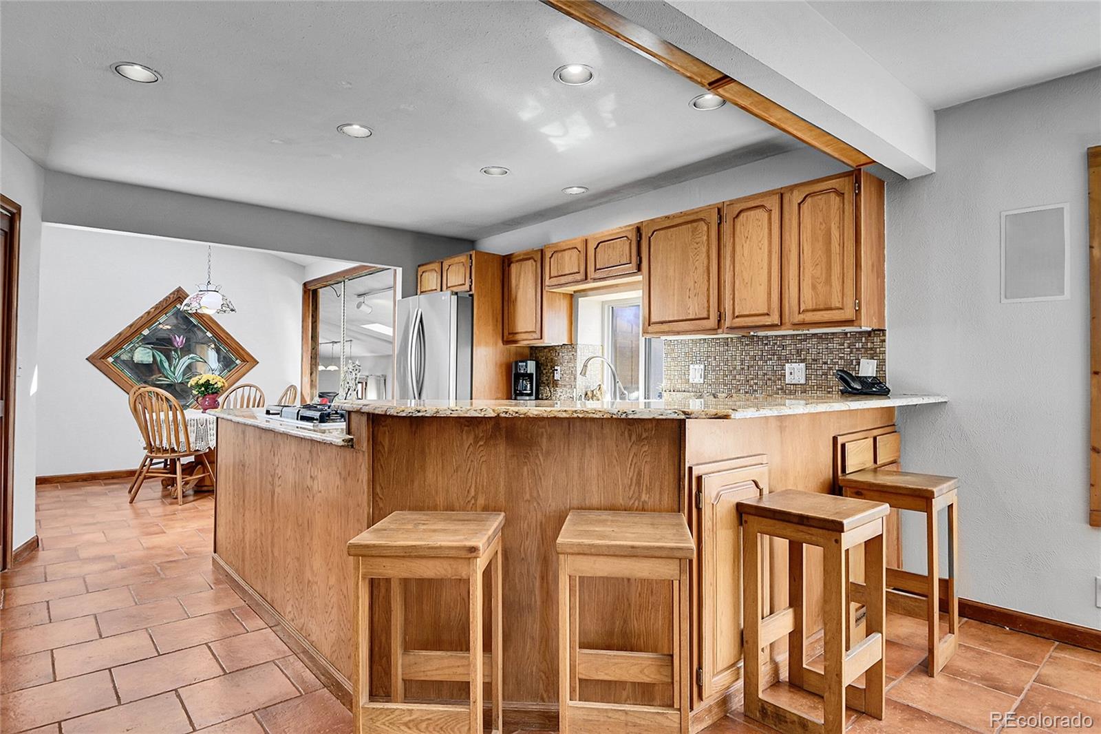 13082 South Wamblee Valley Road Conifer, CO 80433 - Photo 6 of 35 a kitchen with stainless steel appliances granite countertop a stove a sink and a refrigerator