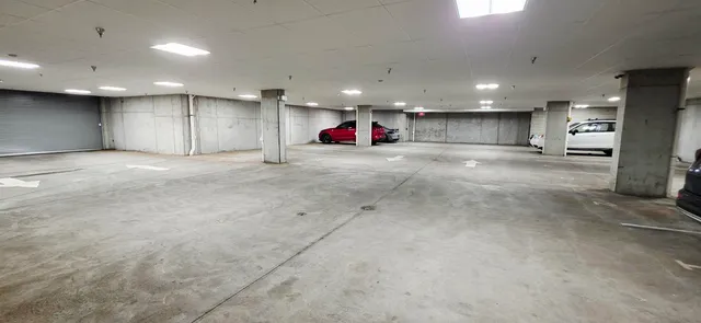 an empty room with kitchen and a refrigerator