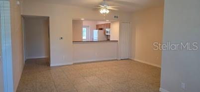26172 Explorer Road, Unit 2 Punta Gorda, FL 33983 - Photo 2 of 10 an empty room with kitchen view and windows