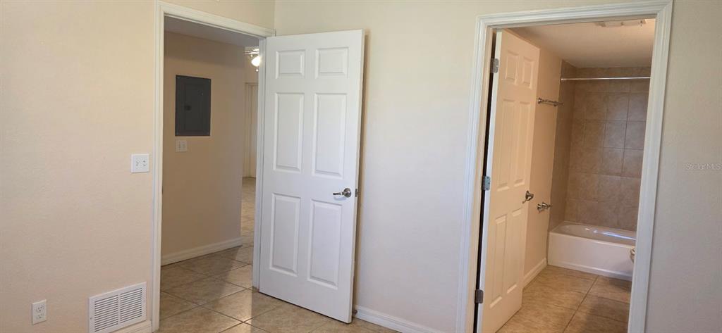 26172 Explorer Road, Unit 2 Punta Gorda, FL 33983 - Photo 9 of 10 a view of a bathroom with a glass door and a sink