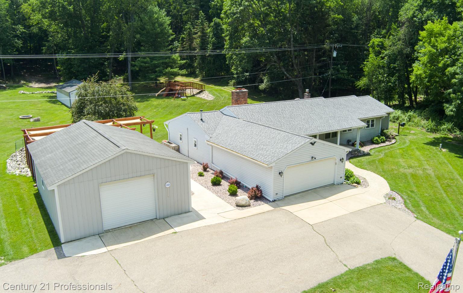 1790 Kent Road Ortonville, MI 48462 - Photo 55 of 64 Expansive property featuring a light gray ranch-style home with an attached two-car garage and an additional detached garage with a single bay