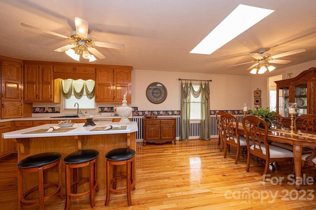 3808 Grace Chapel Road Granite Falls, NC 28630 - Photo 11 of 48 a kitchen with a dining table chairs and white cabinets