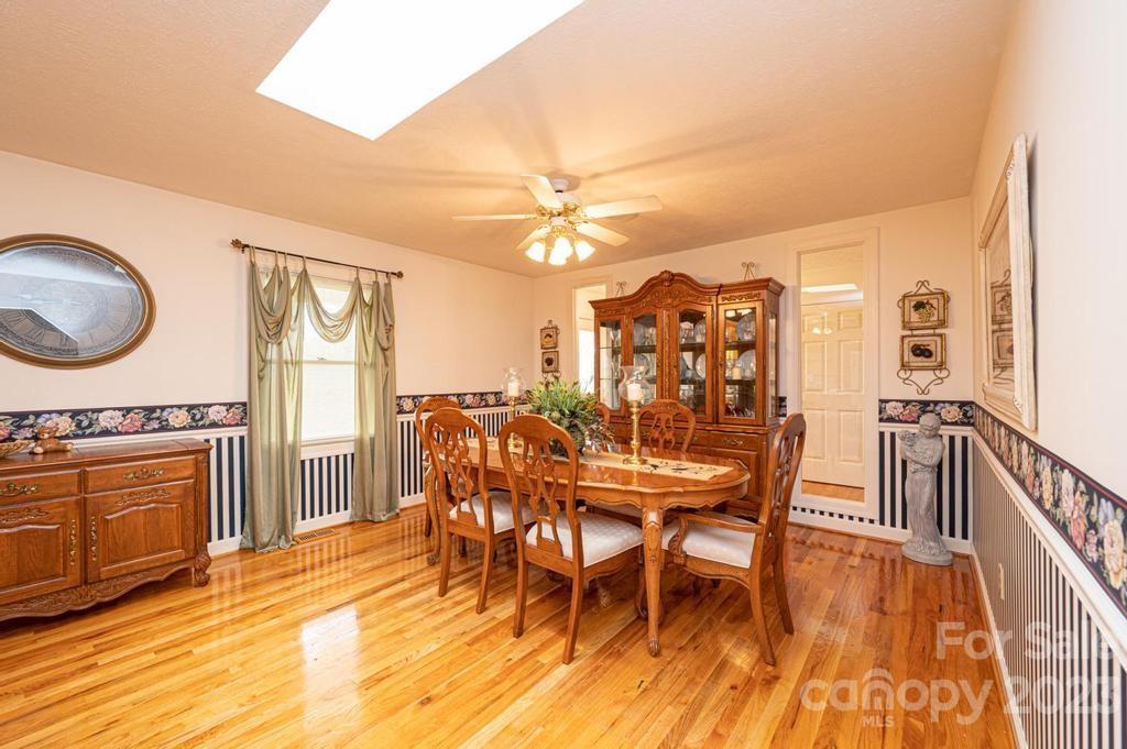 3808 Grace Chapel Road Granite Falls, NC 28630 - Photo 12 of 48 a view of a dining room with furniture and wooden floor