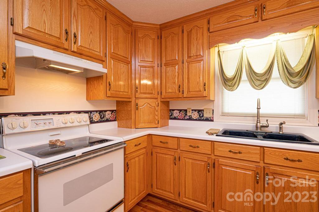 3808 Grace Chapel Road Granite Falls, NC 28630 - Photo 14 of 48 a kitchen with stainless steel appliances granite countertop a sink and cabinets