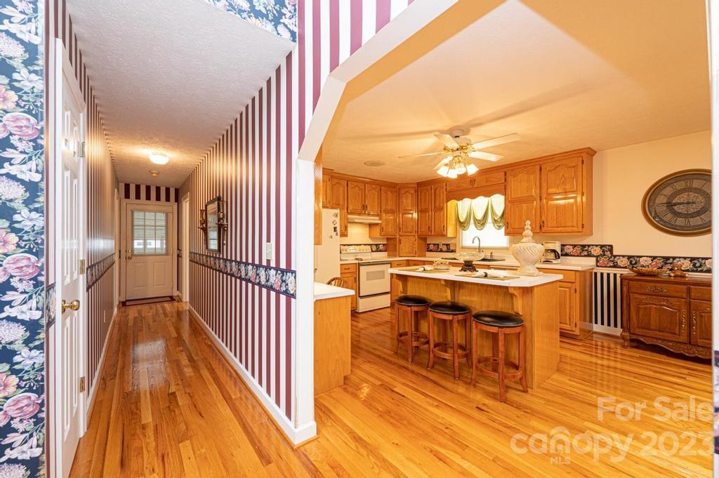 3808 Grace Chapel Road Granite Falls, NC 28630 - Photo 16 of 48 a kitchen with stainless steel appliances kitchen island granite countertop a sink and cabinets