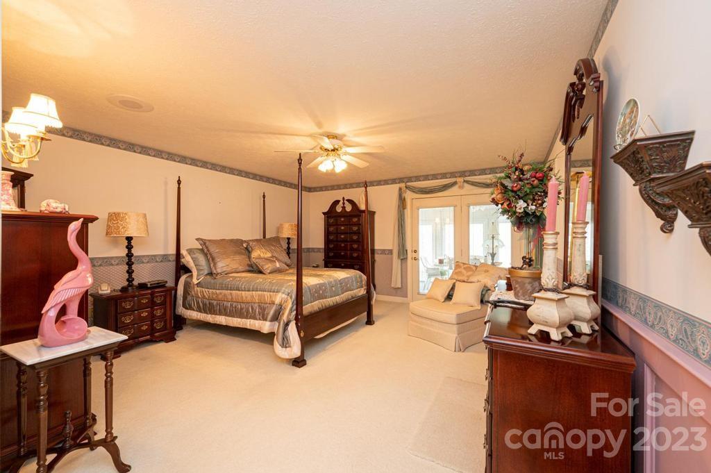 3808 Grace Chapel Road Granite Falls, NC 28630 - Photo 24 of 48 a bedroom with furniture and a chandelier