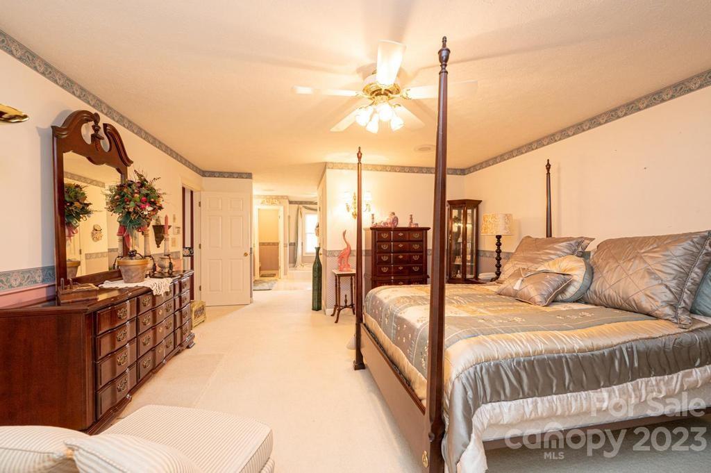 3808 Grace Chapel Road Granite Falls, NC 28630 - Photo 25 of 48 a view of a bedroom with furniture and floor to ceiling window
