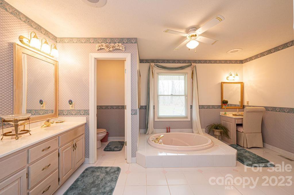 3808 Grace Chapel Road Granite Falls, NC 28630 - Photo 26 of 48 a spacious bathroom with a double vanity sink a mirror and a bathtub