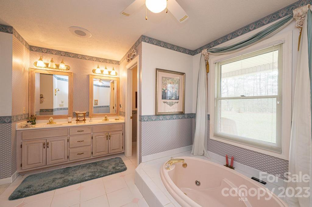 3808 Grace Chapel Road Granite Falls, NC 28630 - Photo 27 of 48 a spacious bathroom with a tub sink shower and mirror