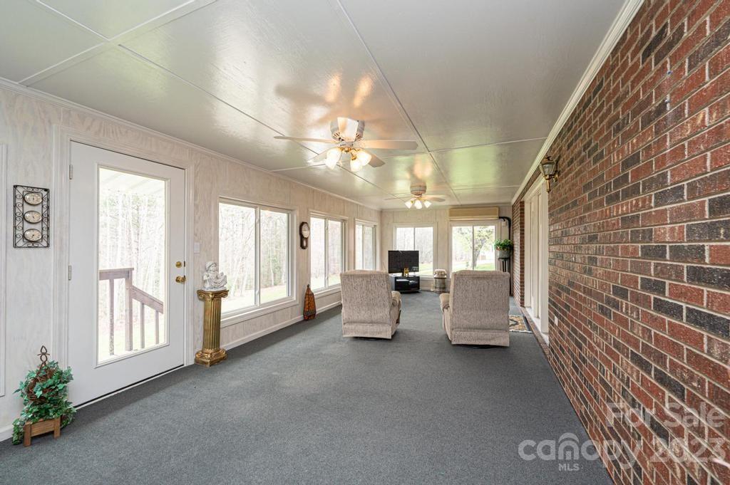 3808 Grace Chapel Road Granite Falls, NC 28630 - Photo 30 of 48 a living room with furniture and a chandelier