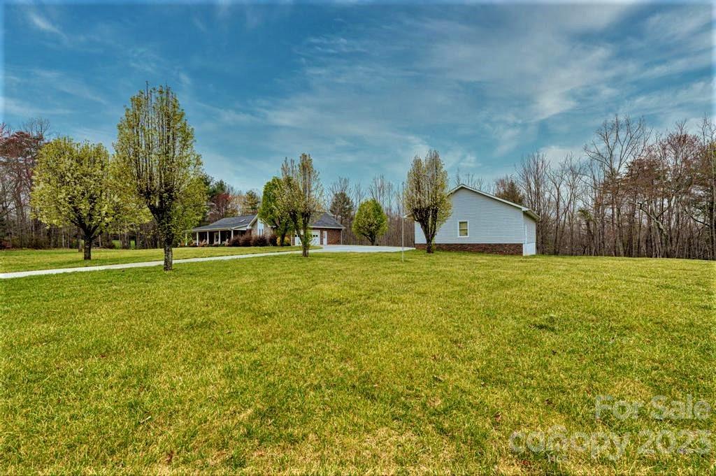3808 Grace Chapel Road Granite Falls, NC 28630 - Photo 46 of 48 a view of a house with a big yard and a large trees