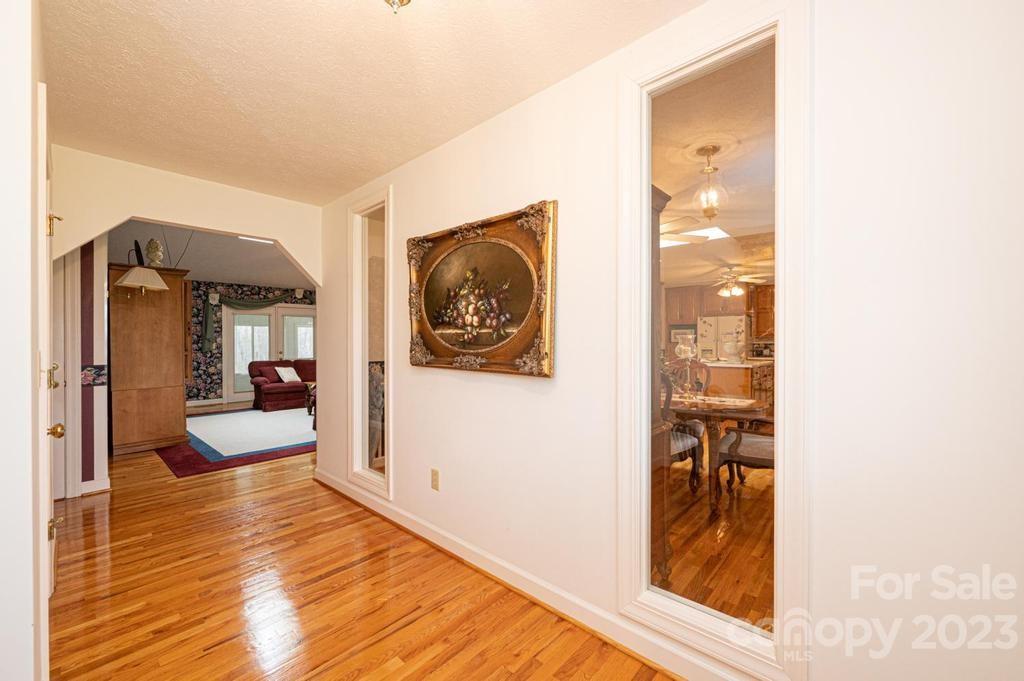 3808 Grace Chapel Road Granite Falls, NC 28630 - Photo 7 of 48 a view of a hallway with wooden floor and furniture