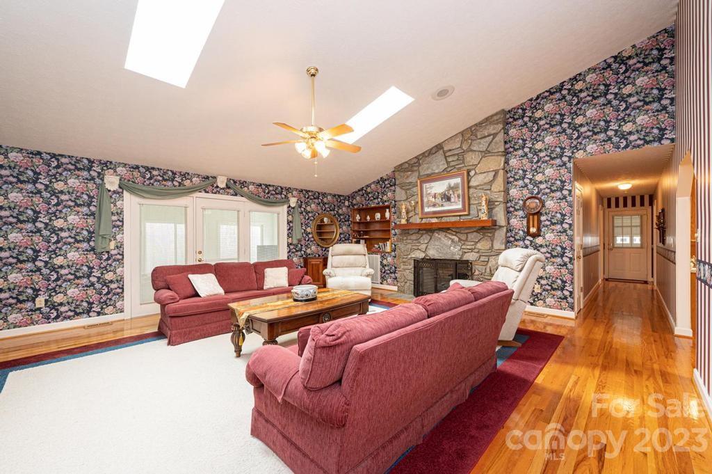 3808 Grace Chapel Road Granite Falls, NC 28630 - Photo 8 of 48 a living room with fireplace furniture and a chandelier