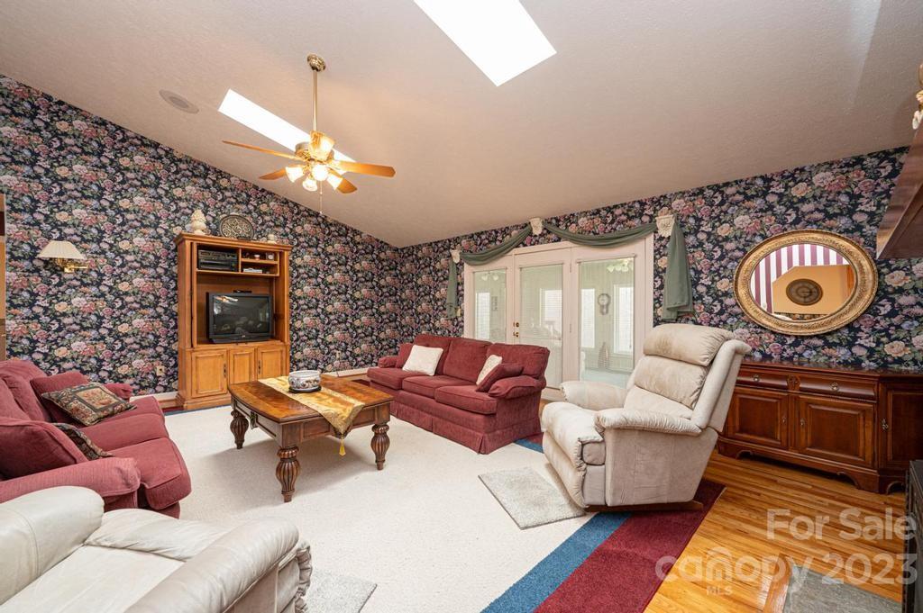 3808 Grace Chapel Road Granite Falls, NC 28630 - Photo 10 of 48 a living room with furniture a chandelier and a rug