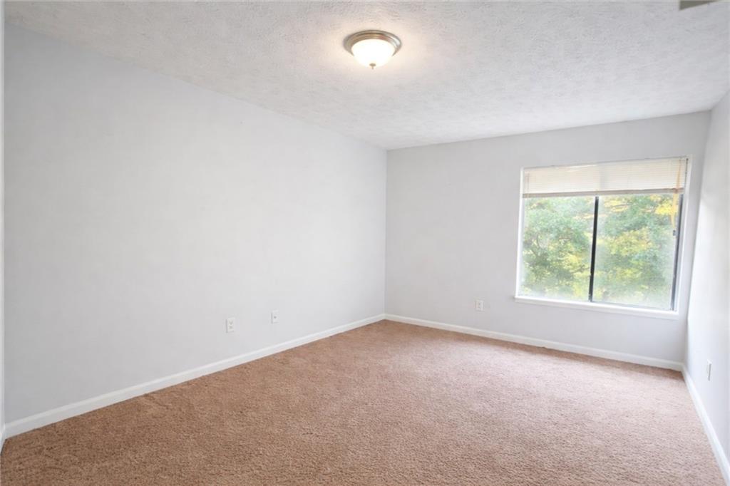 3575 Oakvale Road, Unit 420 Decatur, GA 30034 - Photo 7 of 16 an empty room with a window