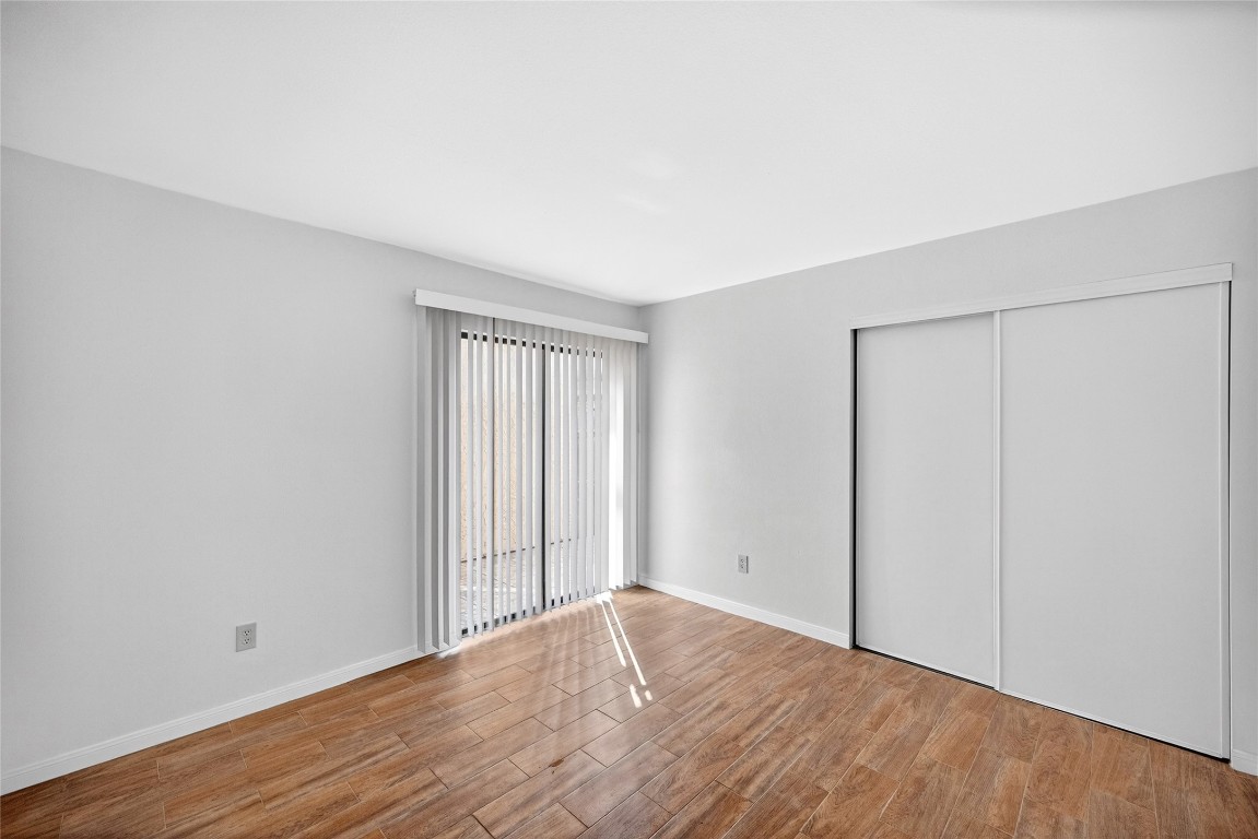 5000 Milwee Street, Unit 61 Houston, TX 77092 - Photo 17 of 42 a view of an empty room with wooden floor