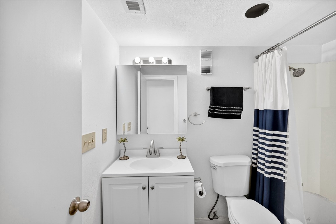 5000 Milwee Street, Unit 61 Houston, TX 77092 - Photo 18 of 42 a bathroom with a sink a toilet a mirror and shower