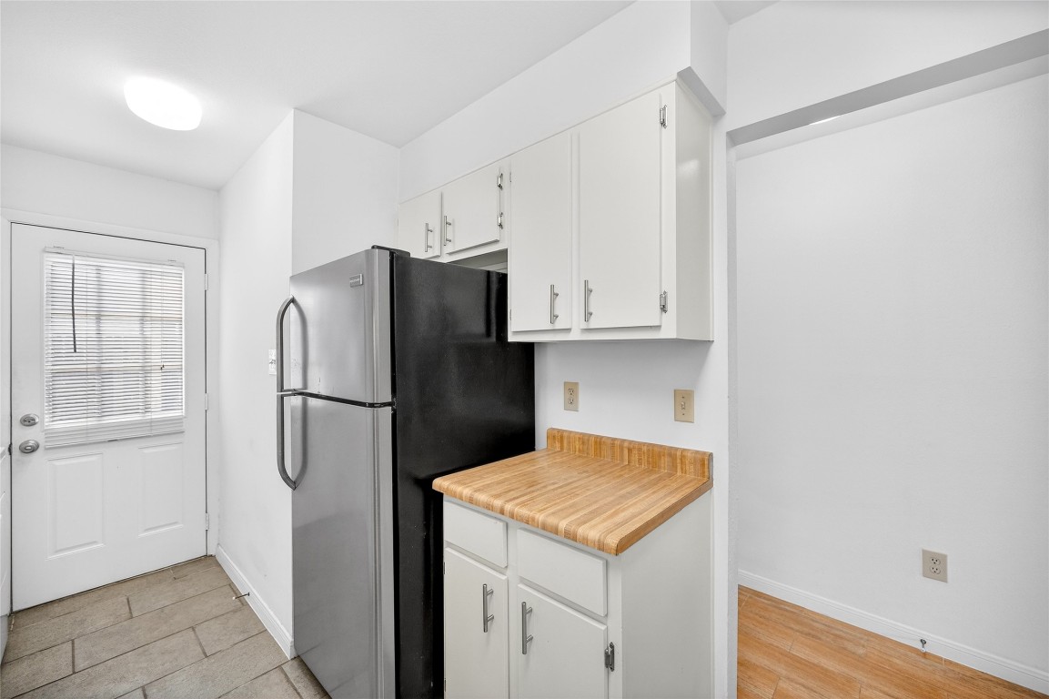 5000 Milwee Street, Unit 61 Houston, TX 77092 - Photo 22 of 42 a kitchen with a refrigerator and a stove top oven