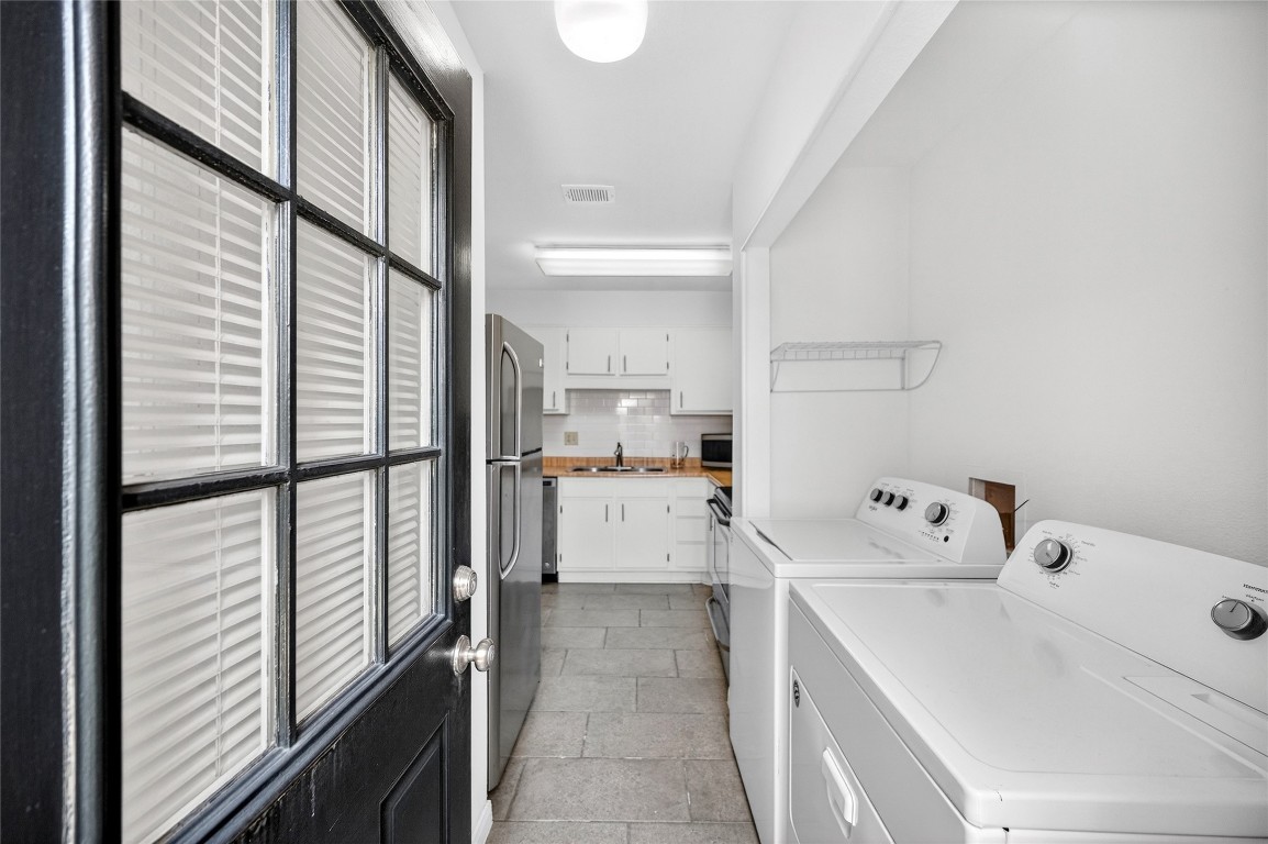 5000 Milwee Street, Unit 61 Houston, TX 77092 - Photo 36 of 42 a view of washer and dryer with kitchen in the background
