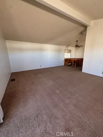 a large kitchen with a refrigerator a sink and dishwasher