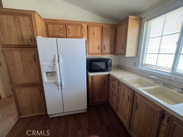a kitchen with refrigerator and window